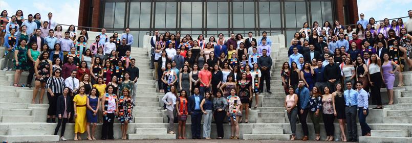 Photo of the participating graduate in the 2018 Latino Congratulatory ceremony. Photo shows three groups of people in posed lines on a set of steps.